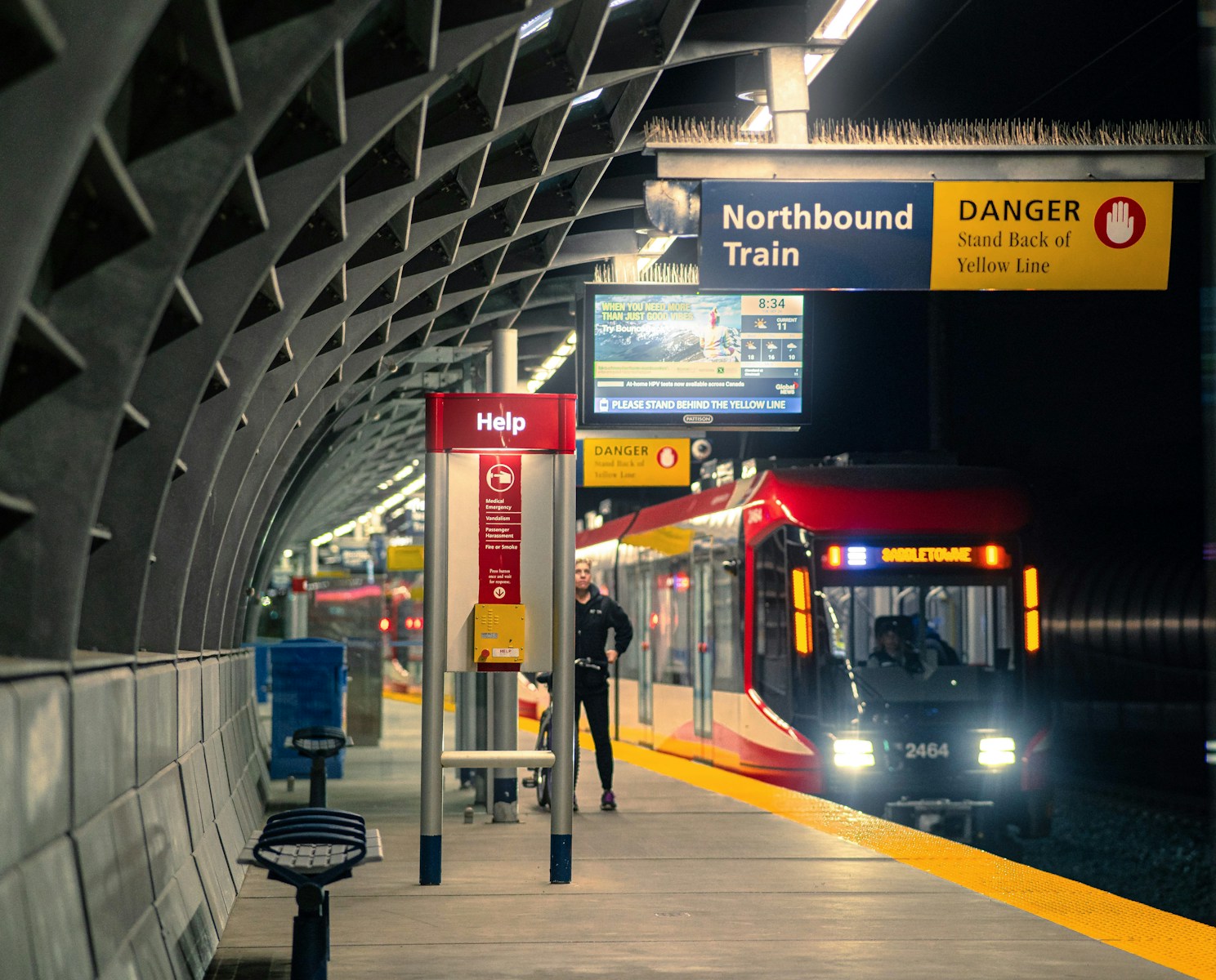 a train pulling into a train station at night